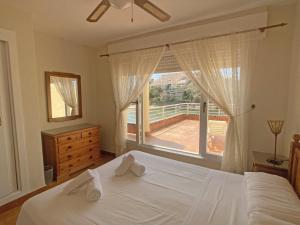 a bedroom with a bed and a large window at Spanish Connection - Urbanizacion Arpon in La Manga del Mar Menor +29 photos
