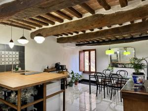 a kitchen and dining room with a table and chairs at MontalciNest in Montalcino