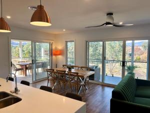 a kitchen and living room with a table and chairs at House on the hill in Wodonga