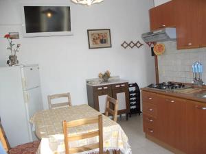 a kitchen with a table and a kitchen with a stove at Blu Mariner in Vada
