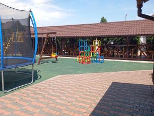 a playground with a play equipment on a tennis court at Three Aces in Velikaya Dobronʼ