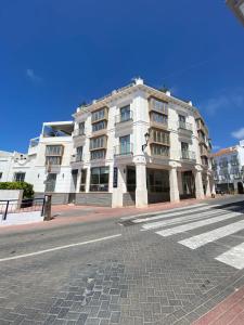 a large white building on the side of a street at La Puerta de Nerja BOUTIQUE - Adults Recommended in Nerja