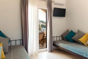 a living room with a couch and a large mirror at Casa Evanti in Syvota
