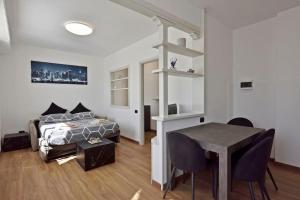 a bedroom with a bed and a desk and a table at Zona Panoramica - Bluchalet in Aosta