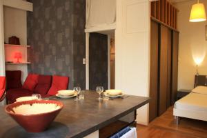 uma cozinha com uma mesa com uma tigela vermelha em Appart' Sathonay em Lyon