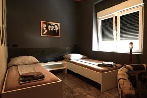 a bedroom with two beds and a window at Rock Rooms Pula in Pula