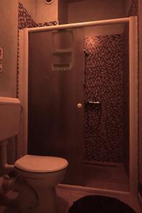 a bathroom with a shower with a toilet at Rock Rooms Pula in Pula