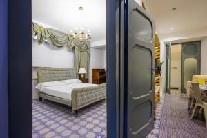 a bedroom with a bed and a room with a window at Allegra Experience in Taormina