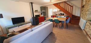 a living room with a couch and a table at Le Domaine de la Férière in Sallen