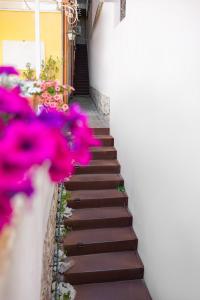 a stairway with purple flowers in front of a building at Allegra Experience in Taormina