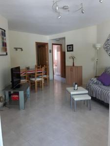 a living room with a couch and a table at Bungalow in Calpe - swimming pool and tennis court in Calpe