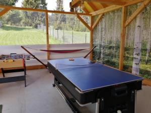 a ping pong table in a pavilion with a ping pong tableablish at Mounty vendégház in Borzont +33 photos