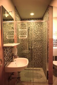 a bathroom with a sink and a shower at Rock Rooms Pula in Pula