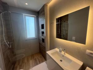 a bathroom with a sink and a shower at City Center Suite in Tirana +14 photos