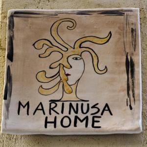 a sign on a wall with a picture of a woman at Marinusa home luxury - air conditioned - wi-fi in Siracusa