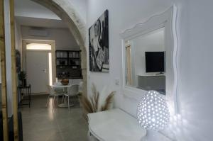 a living room with a white couch and a mirror at Marinusa home luxury - air conditioned - wi-fi in Siracusa
