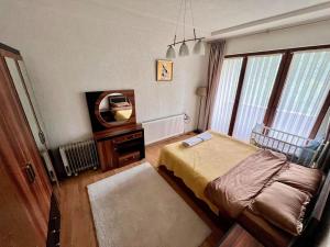 a bedroom with a bed and a tv in it at Mountain Garden House in Prizren