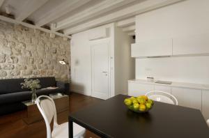 a kitchen and living room with a black table and chairs at Apartments Eleganca in Dubrovnik