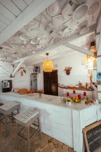 a kitchen with a counter and chairs in a room at LaWanda9 in Vama Veche