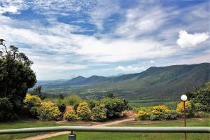 a view of a valley with mountains in the distance at Mountain Edge Escape in Eungella