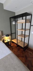 a bedroom with a bed and a book shelf at Hotel Alicante Lisboa in Lisbon