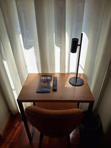 a wooden table with a lamp and a book on it at Hotel Alicante Lisboa in Lisbon +37 photos