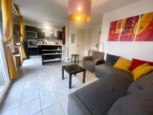 a living room with a couch and a table at Neyrpic - Cocon douillet -balcon in Rhut