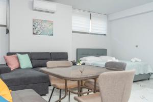 a living room with a couch and a table at Niki's Apartments in Faraí