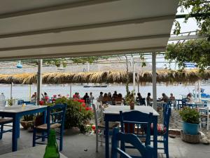 a restaurant with tables and chairs and a view of the water at Villa Telendos in Telendos