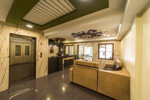 a living room with a couch in a room at SAU Residency in Kanchipuram