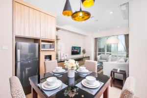 a kitchen and living room with a table and chairs at Lanea by Kozystay - Setiabudi in Jakarta