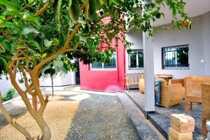 a living room with a red door and a tree at villla tourama in Saly Niakh-Niakhal +9 photos