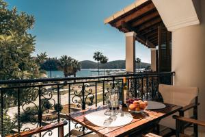 a table with a bowl of fruit on a balcony at Casa Evanti in Syvota