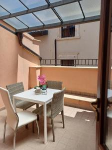 a table and chairs on a balcony with a glass roof at B&B Eden in LʼAquila
