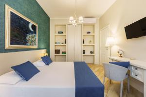 a bedroom with a bed and a desk and a television at It’s Room in Naples