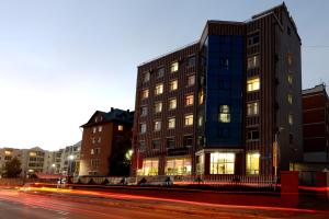 a building on the side of a street at night at Zolo Hotel in Ulaanbaatar