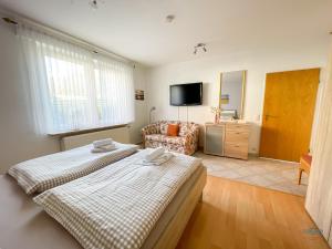 a living room with two beds and a couch at Ferienwohnung Seerose in Cuxhaven