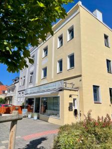 a large building with a store in front of it at Strandbude 2 Döse in Cuxhaven