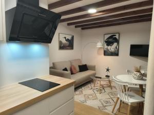 a living room with a couch and a tv at A Casa Da Canle in Braño