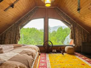 a bed in a room with a large window at Casa Veveritelor in Bran