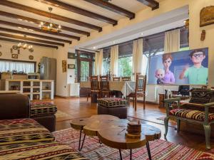 a large living room with a large screen tv at Casa Veveritelor in Bran