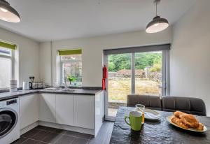 a kitchen with a table with bread on it at Finest Retreats - Blaen Ddol in Betws-y-coed
