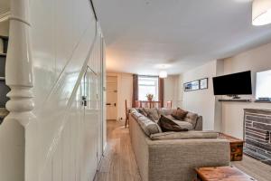 a living room with a couch and a tv at Finest Retreats - Blaen Ddol in Betws-y-coed