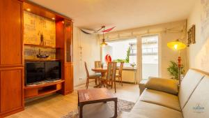 a living room with a couch and a table at Urlaub mit Seesicht Haus Nautic Whg. 201 in Cuxhaven