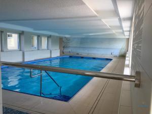 a large swimming pool in a building at Urlaub mit Seesicht Haus Nautic Whg. 201 in Cuxhaven