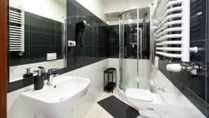 a bathroom with a sink and a glass shower at Willa Celina in Karpacz +64 photos