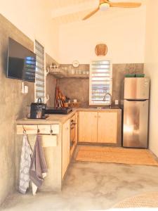 a kitchen with a stainless steel refrigerator and wooden cabinets at 12 Casa Hermanito in Kralendijk