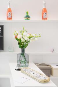 a vase with flowers in it on a table at It’s Room in Naples