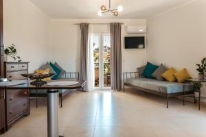 a living room with a couch and a table at Casa Evanti in Syvota