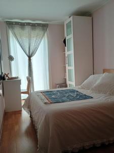 a bedroom with a bed and a large window at El Camarote de Beiramar in Cedeira